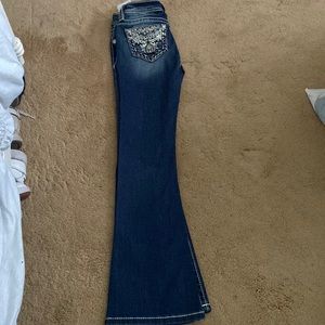 Miss Me jeans kid size 7 with bootcut bottoms and low rise waist, dark blue wash